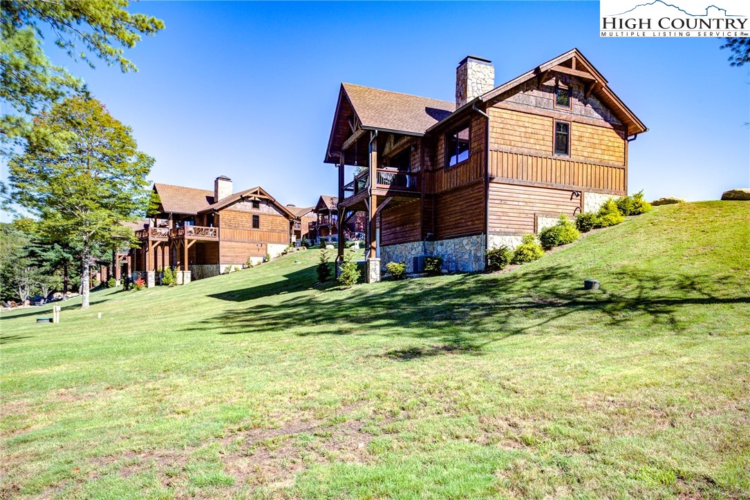 242 Camp Eagle Loop Banner Elk, NC 28604 - Photo 4 of 25 a front view of a house with a yard