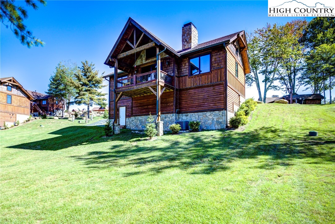 242 Camp Eagle Loop Banner Elk, NC 28604 - Photo 5 of 25 a front view of a house with garden