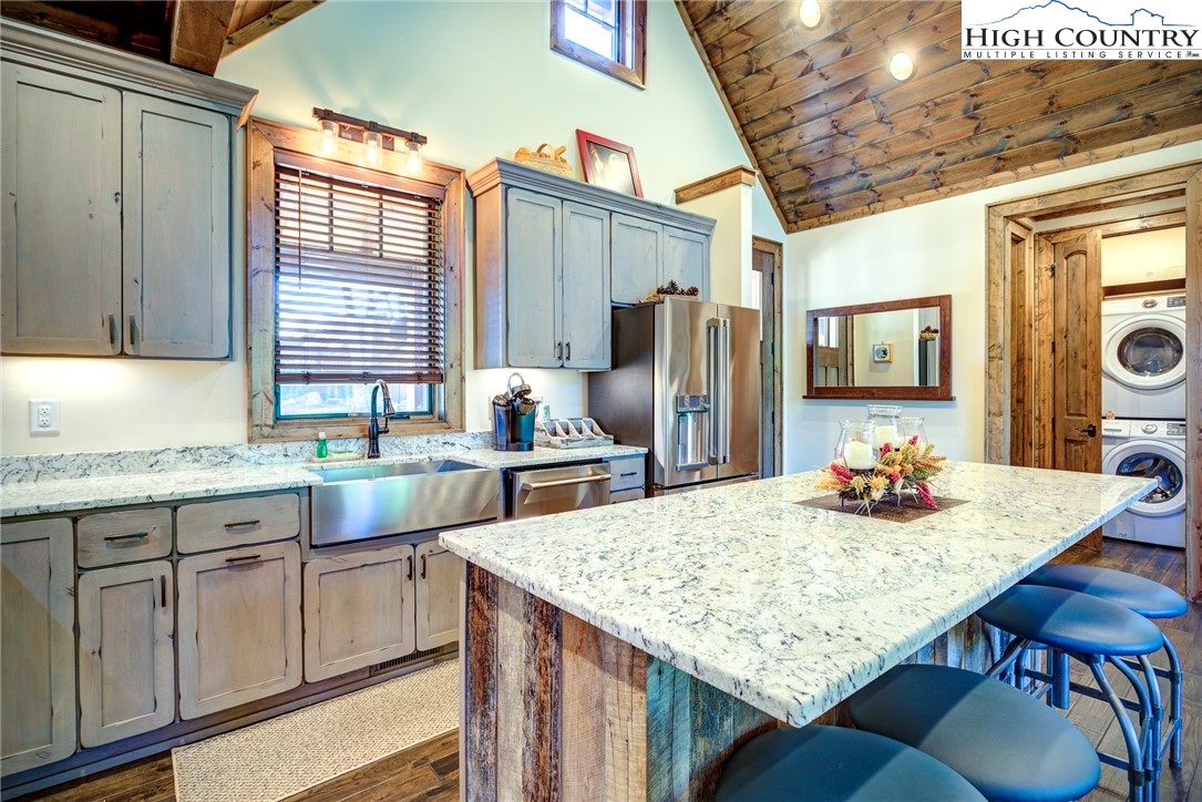 242 Camp Eagle Loop Banner Elk, NC 28604 - Photo 7 of 25 a kitchen with granite countertop kitchen island stainless steel appliances a sink stove and refrigerator