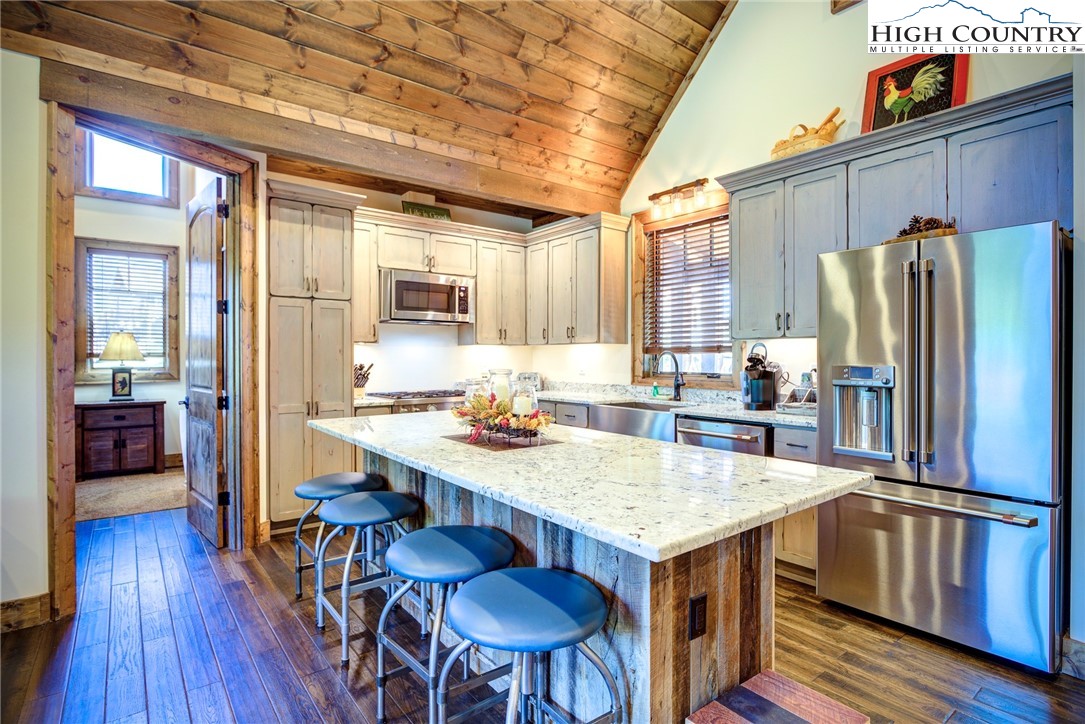 242 Camp Eagle Loop Banner Elk, NC 28604 - Photo 8 of 25 a kitchen with a table chairs refrigerator and cabinets