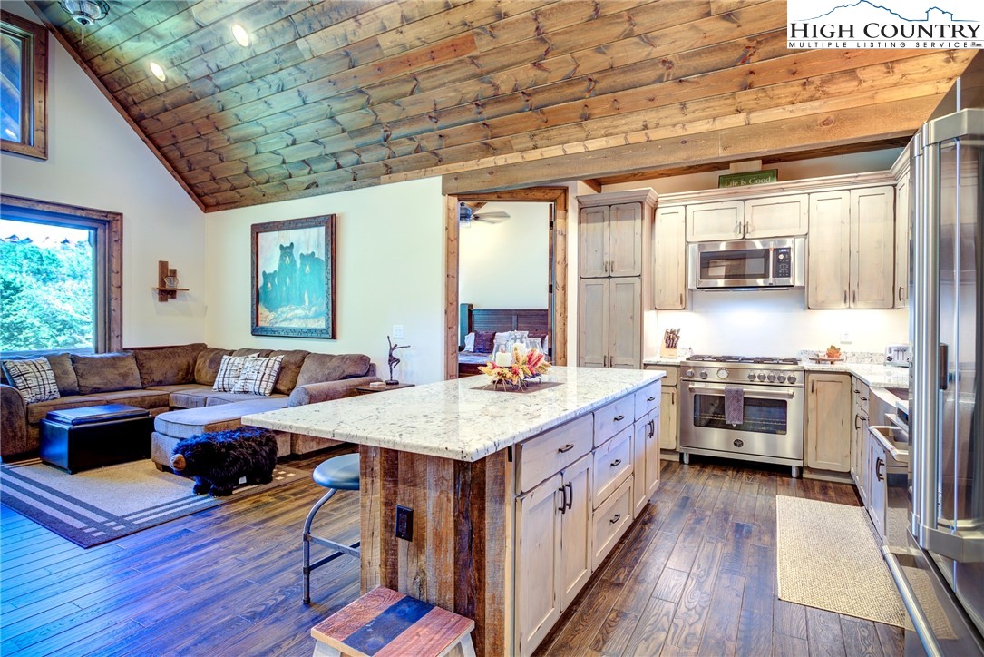 242 Camp Eagle Loop Banner Elk, NC 28604 - Photo 9 of 25 a open kitchen with stainless steel appliances granite countertop a stove and cabinets