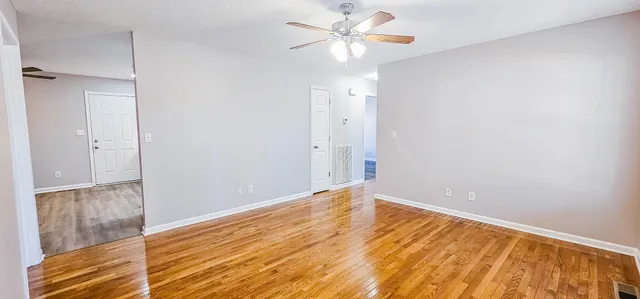 a kitchen with a refrigerator sink and wooden floor
