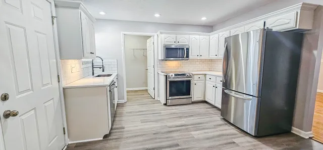 a view of a kitchen with wooden floor