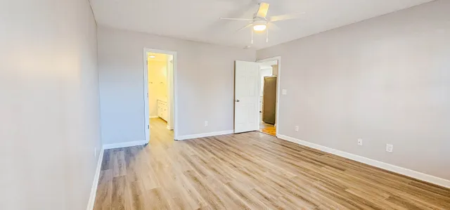 a view of a room with wooden floor
