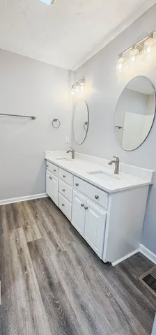 a bathroom with a sink and mirror