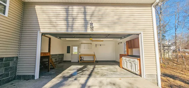 a view of a hallway with a table and chairs