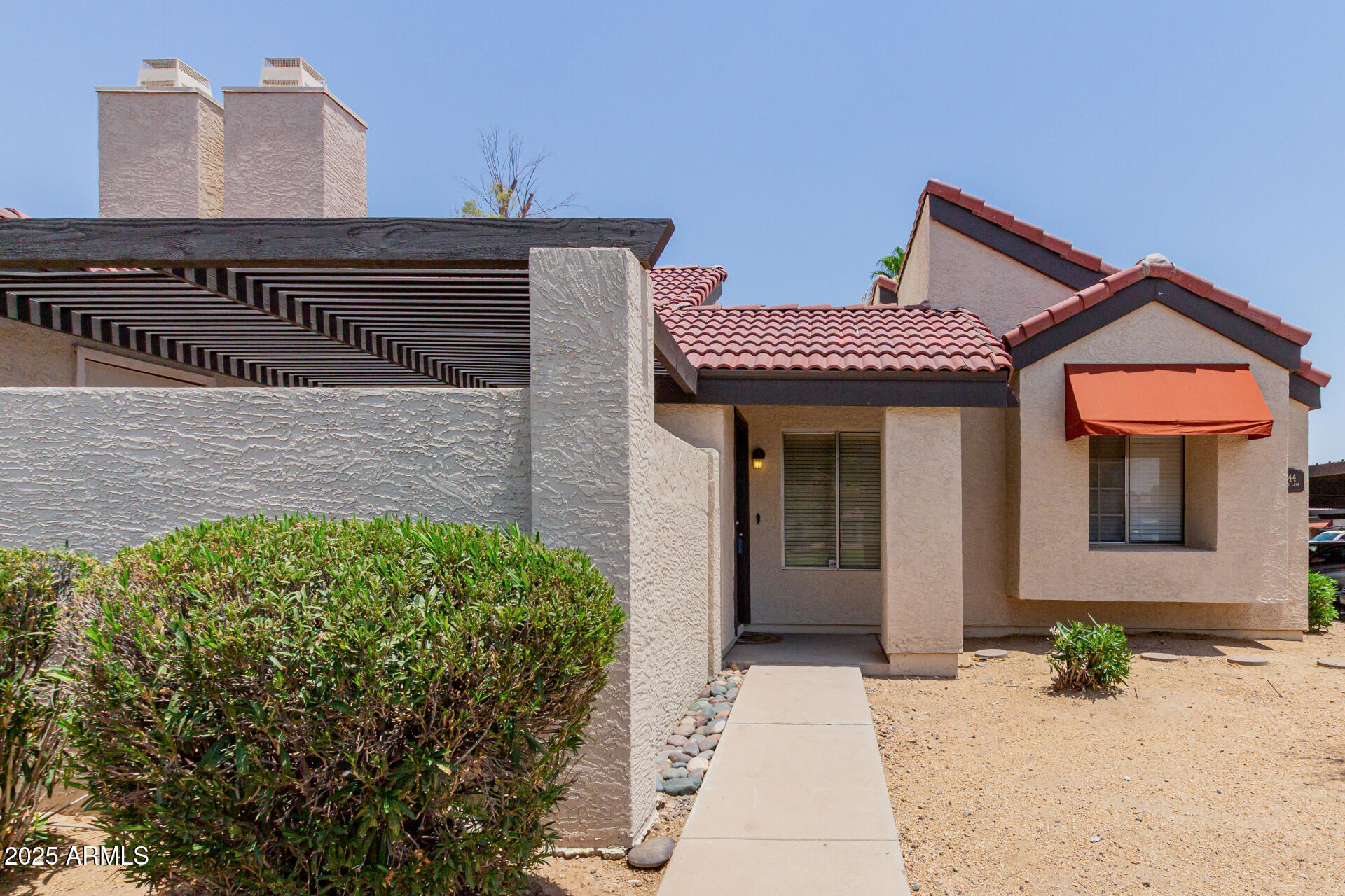2144 East Center Lane, Unit 3 Tempe, AZ 85281 - Photo 1 of 30 a front view of a house with a garden