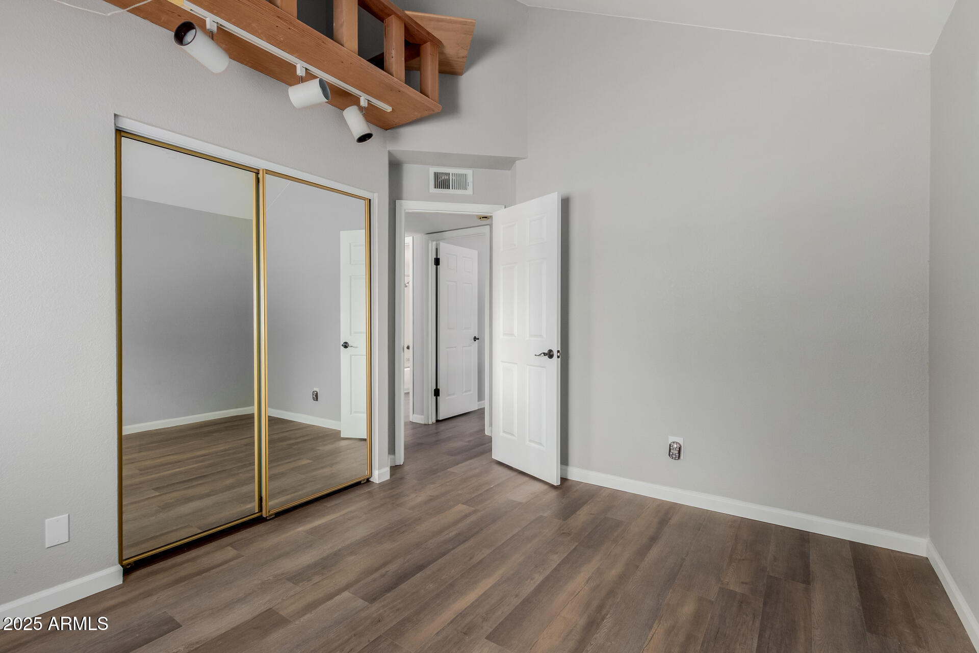 2144 East Center Lane, Unit 3 Tempe, AZ 85281 - Photo 13 of 30 an empty room with wooden floor and windows