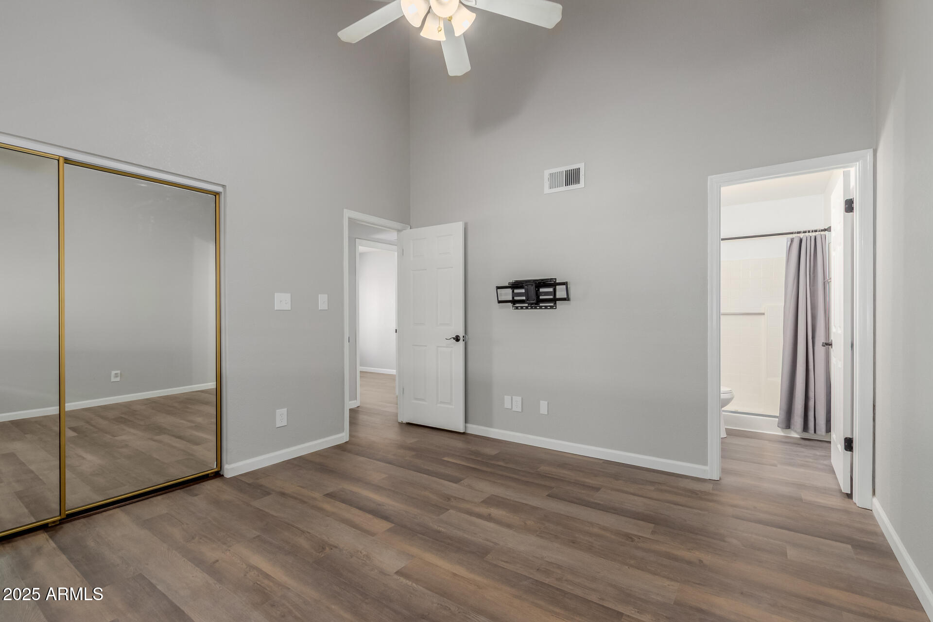 2144 East Center Lane, Unit 3 Tempe, AZ 85281 - Photo 14 of 30 an empty room with wooden floor mirror and windows