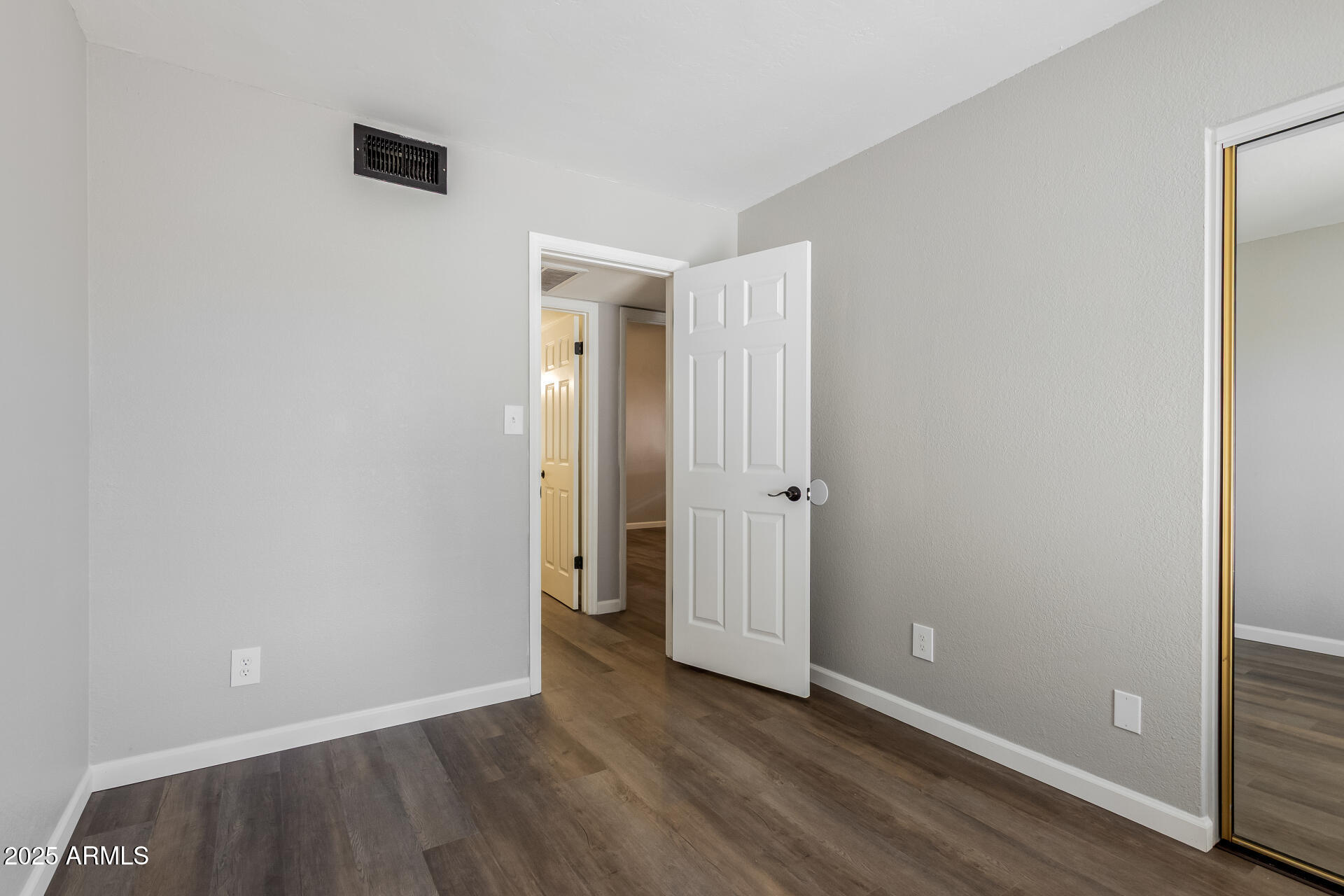 2144 East Center Lane, Unit 3 Tempe, AZ 85281 - Photo 15 of 30 an empty room with wooden floor and closet