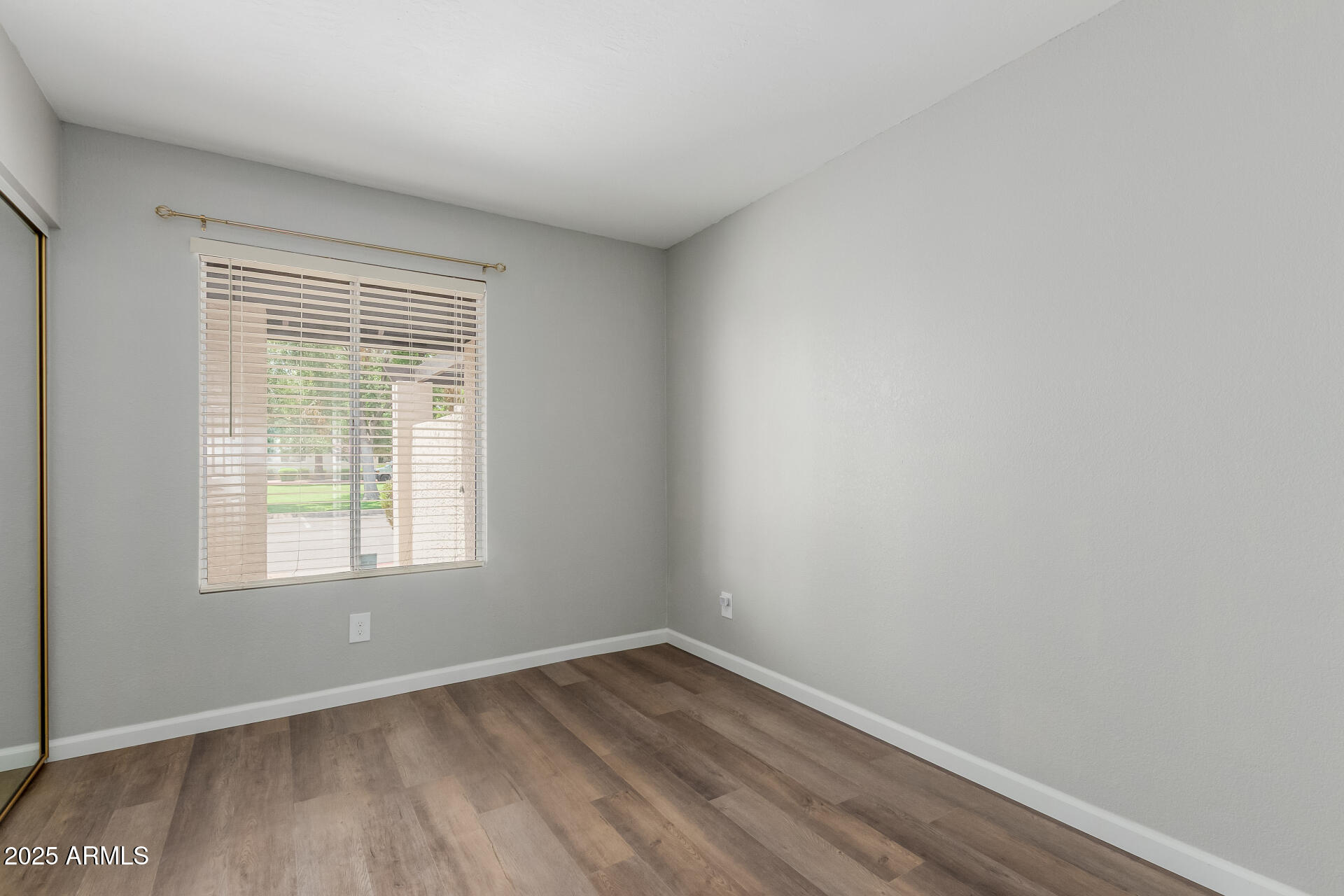 2144 East Center Lane, Unit 3 Tempe, AZ 85281 - Photo 17 of 30 an empty room with wooden floor and windows