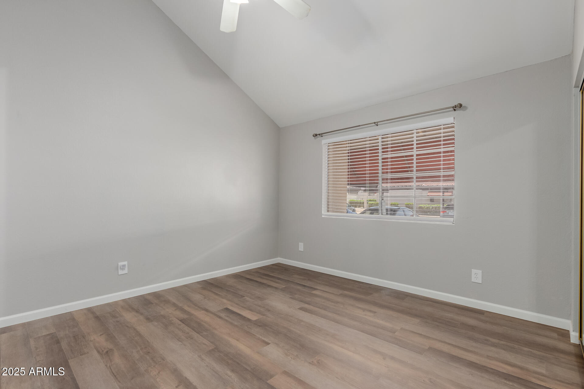 2144 East Center Lane, Unit 3 Tempe, AZ 85281 - Photo 18 of 30 an empty room with wooden floor and windows
