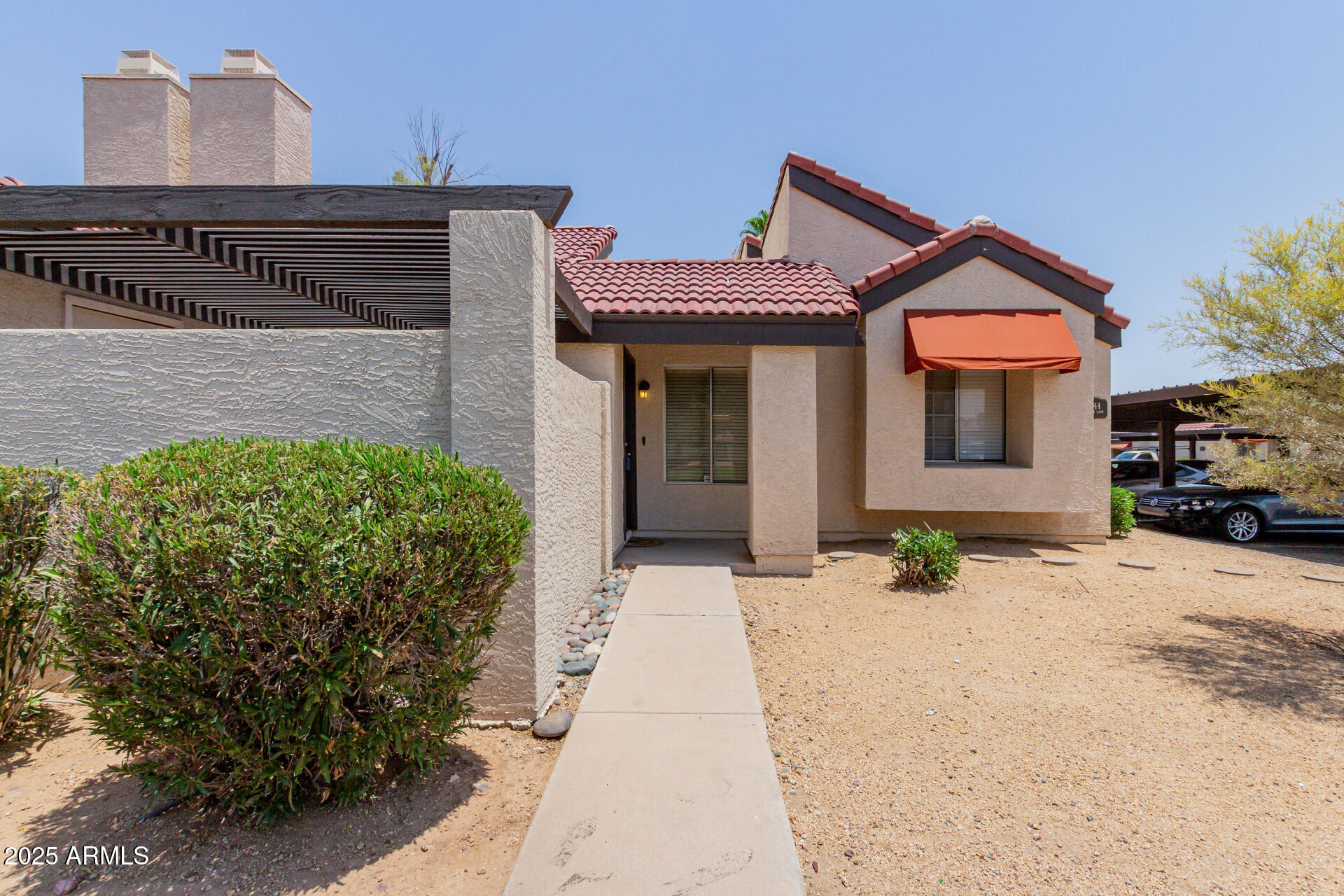 2144 East Center Lane, Unit 3 Tempe, AZ 85281 - Photo 2 of 30 a front view of a house with a yard and a garage