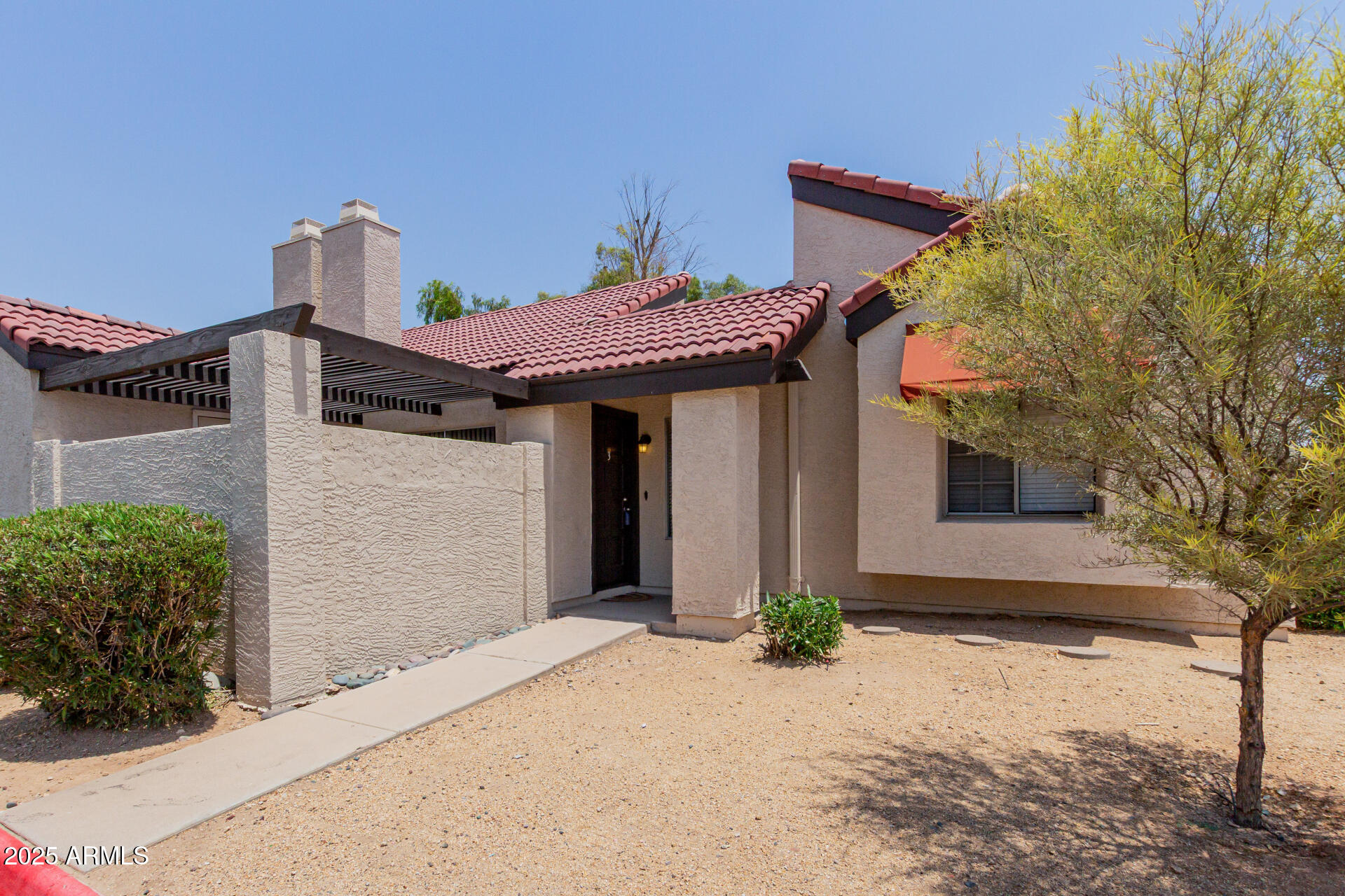 2144 East Center Lane, Unit 3 Tempe, AZ 85281 - Photo 24 of 30 a front view of a house with a yard