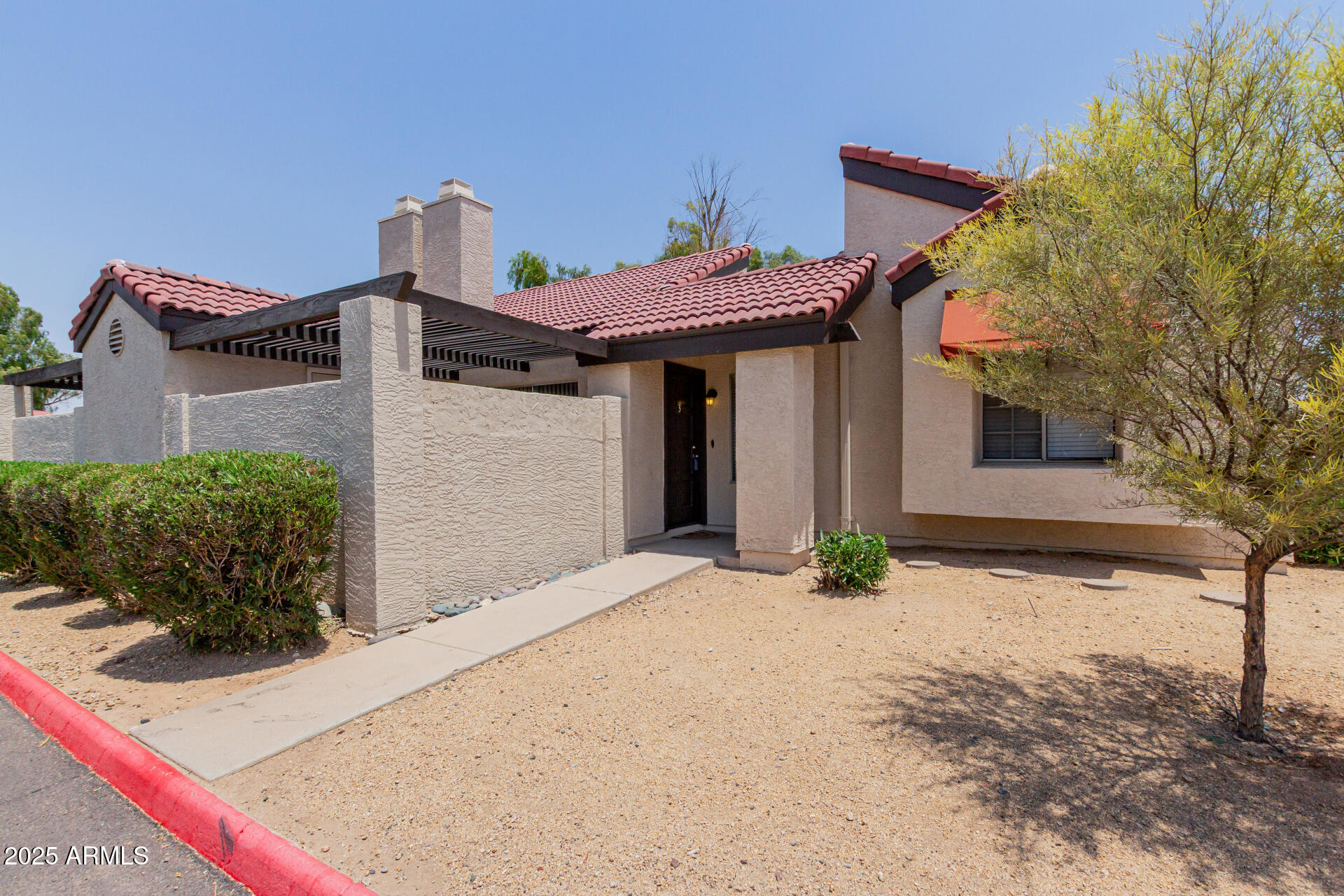 2144 East Center Lane, Unit 3 Tempe, AZ 85281 - Photo 3 of 30 a front view of a house with a yard