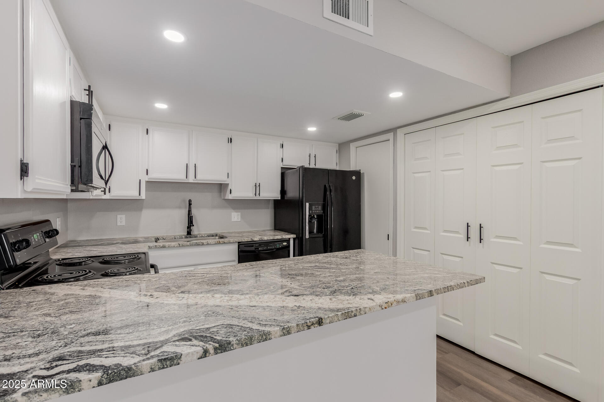 2144 East Center Lane, Unit 3 Tempe, AZ 85281 - Photo 5 of 30 a kitchen with stainless steel appliances granite countertop a sink refrigerator and cabinets