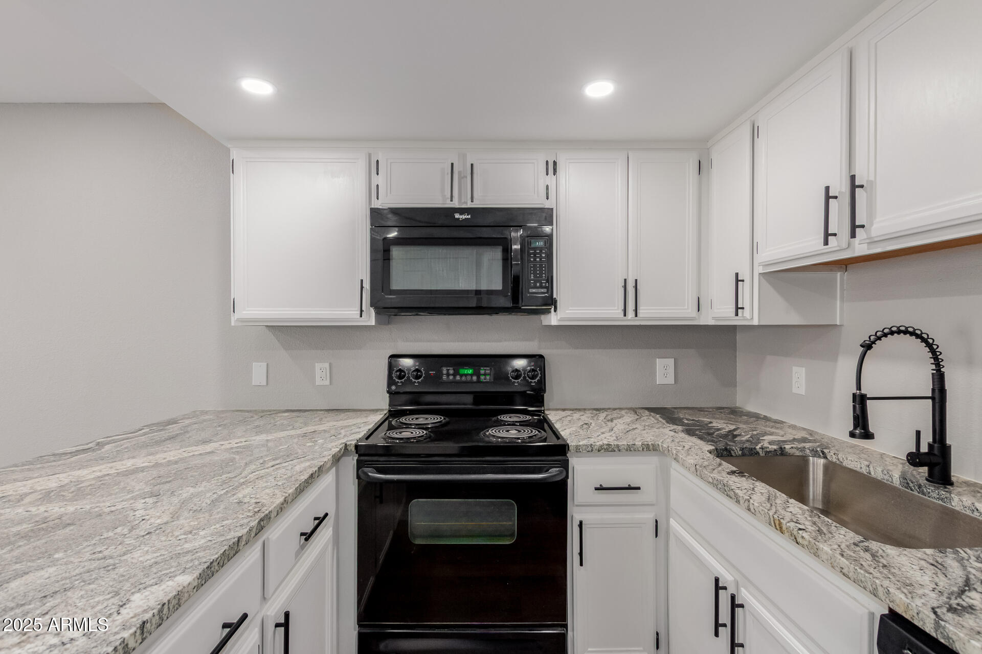 2144 East Center Lane, Unit 3 Tempe, AZ 85281 - Photo 6 of 30 a kitchen with granite countertop a stove top oven sink and cabinets