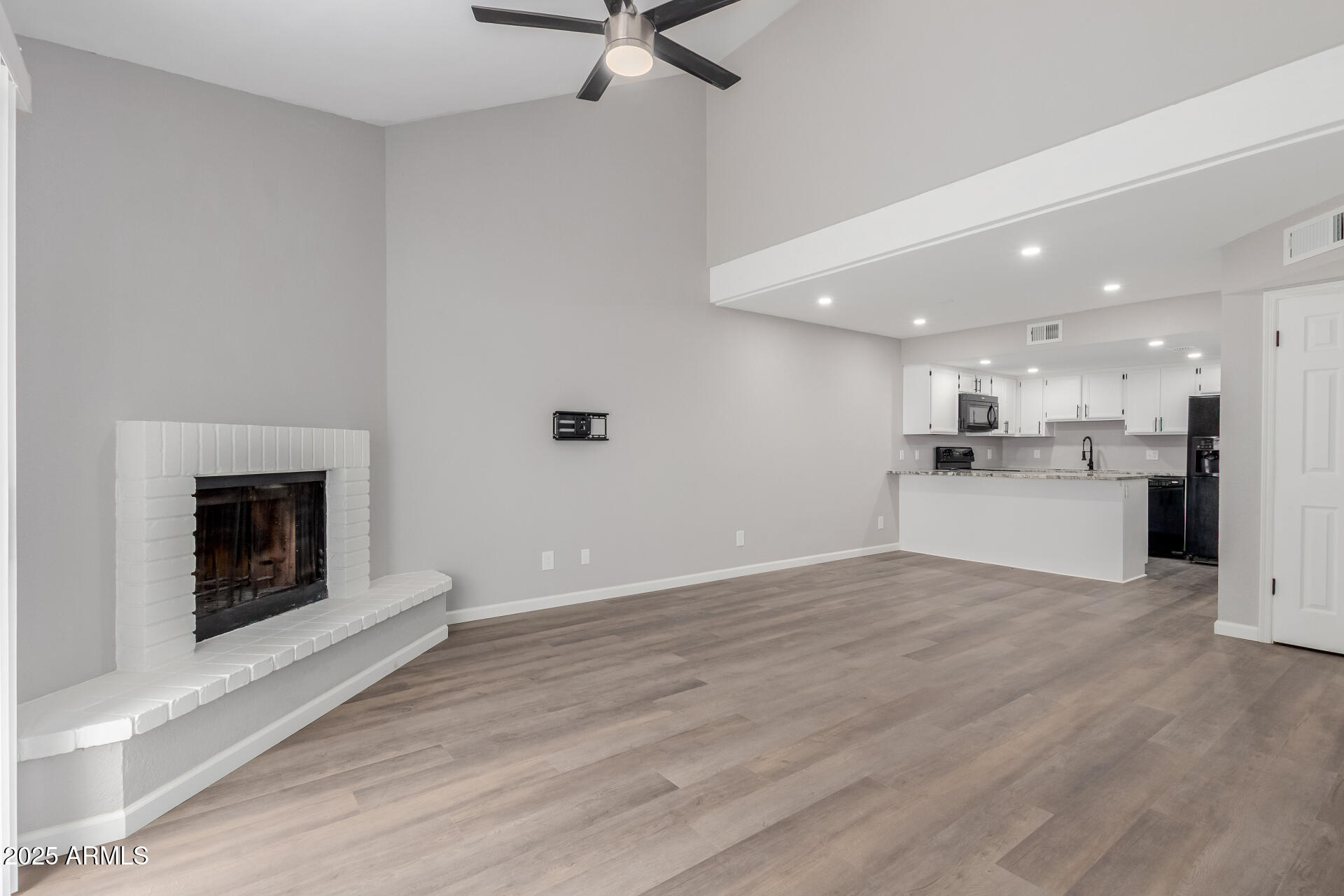 2144 East Center Lane, Unit 3 Tempe, AZ 85281 - Photo 7 of 30 a view of a kitchen with a sink a fireplace and window