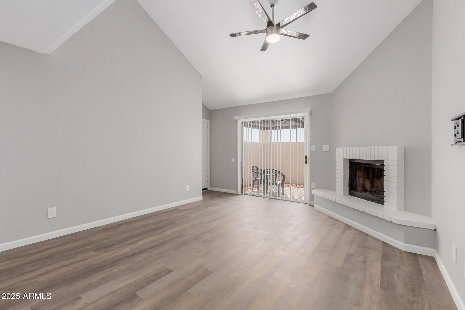 2144 East Center Lane, Unit 3 Tempe, AZ 85281 - Photo 8 of 30 an empty room with wooden floor fireplace and windows