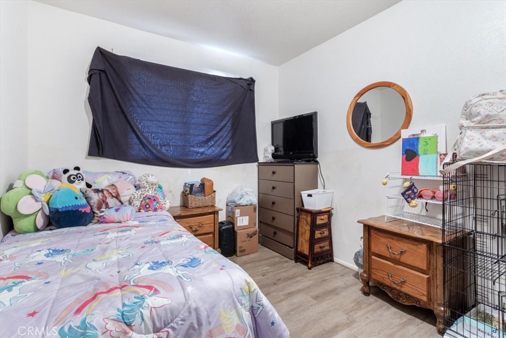 13645 Gilbert Street North Edwards, CA 93523 - Photo 6 of 12 a bedroom with bed and a fish tank on dresser