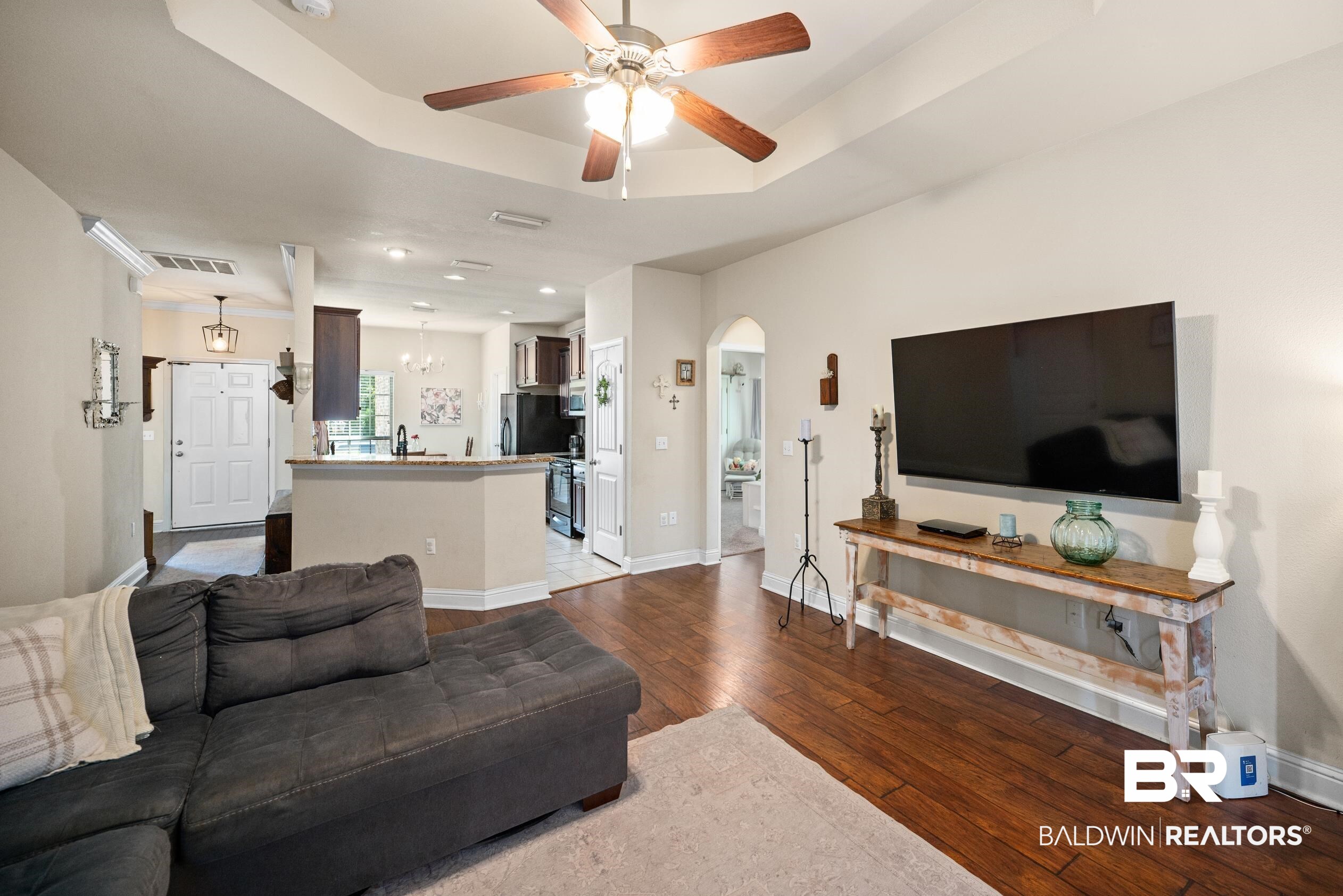 745 Bonaventure Street Fairhope, AL 36532 - Photo 3 of 36 Living room featuring light wood-type flooring, a raised ceiling, sink, and ceiling fan