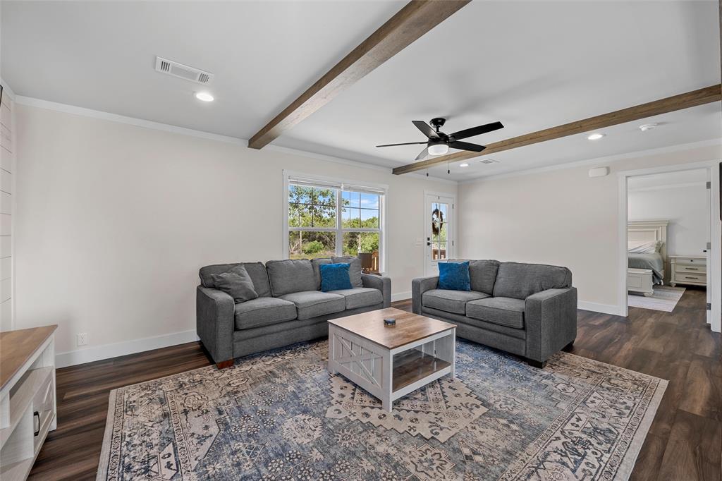 3050 Clater Powell Road Waco, TX 76705 - Photo 12 of 39 a living room with furniture a ceiling fan and a rug
