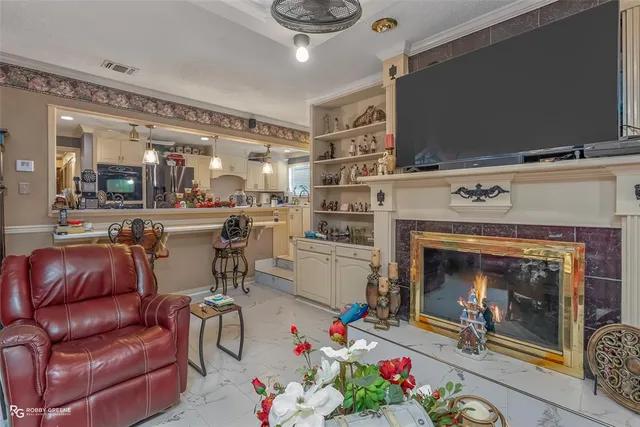 a living room with furniture flowerpot and a chandelier
