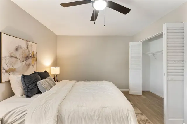 a bedroom with a bed and ceiling fan