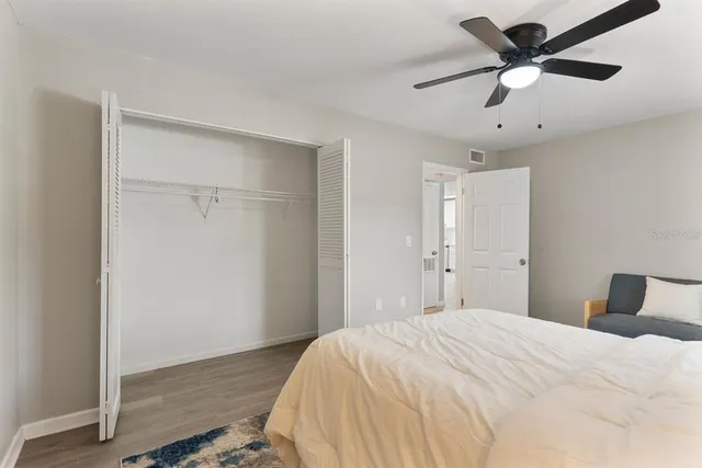 a bedroom with a bed and a ceiling fan