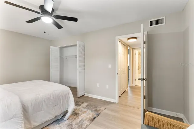 a bedroom with a large bed and a chandelier