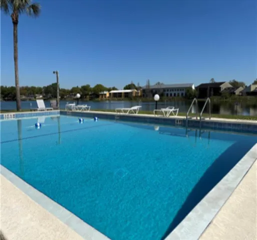 a view of a swimming pool and an outdoor seating