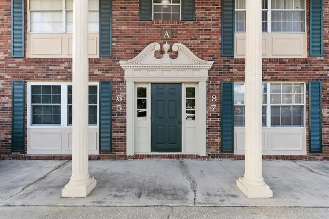 a view of a brick house with a entrance door