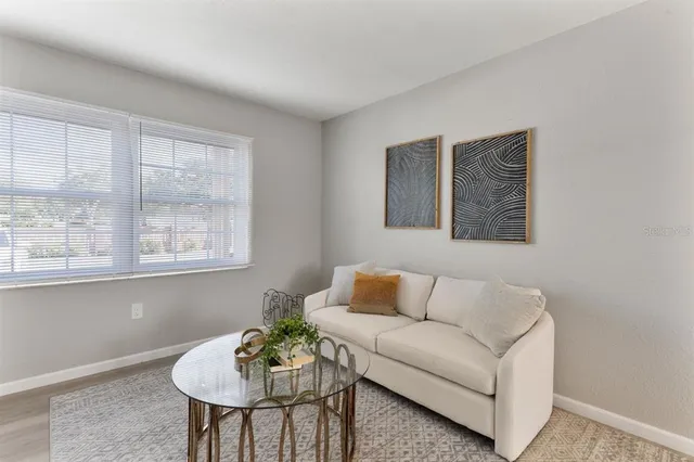 a living room with furniture and a potted plant