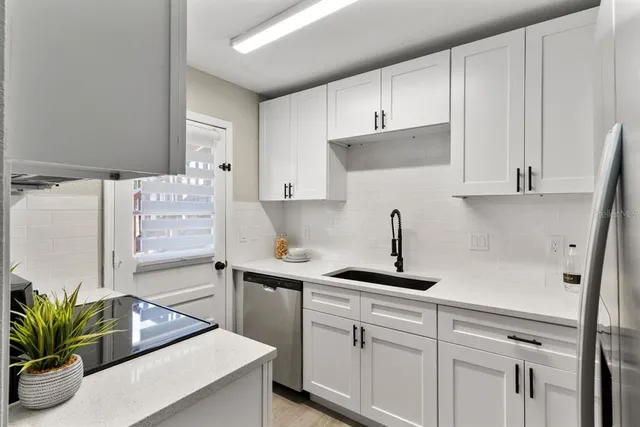 a kitchen with stainless steel appliances white cabinets and a stove