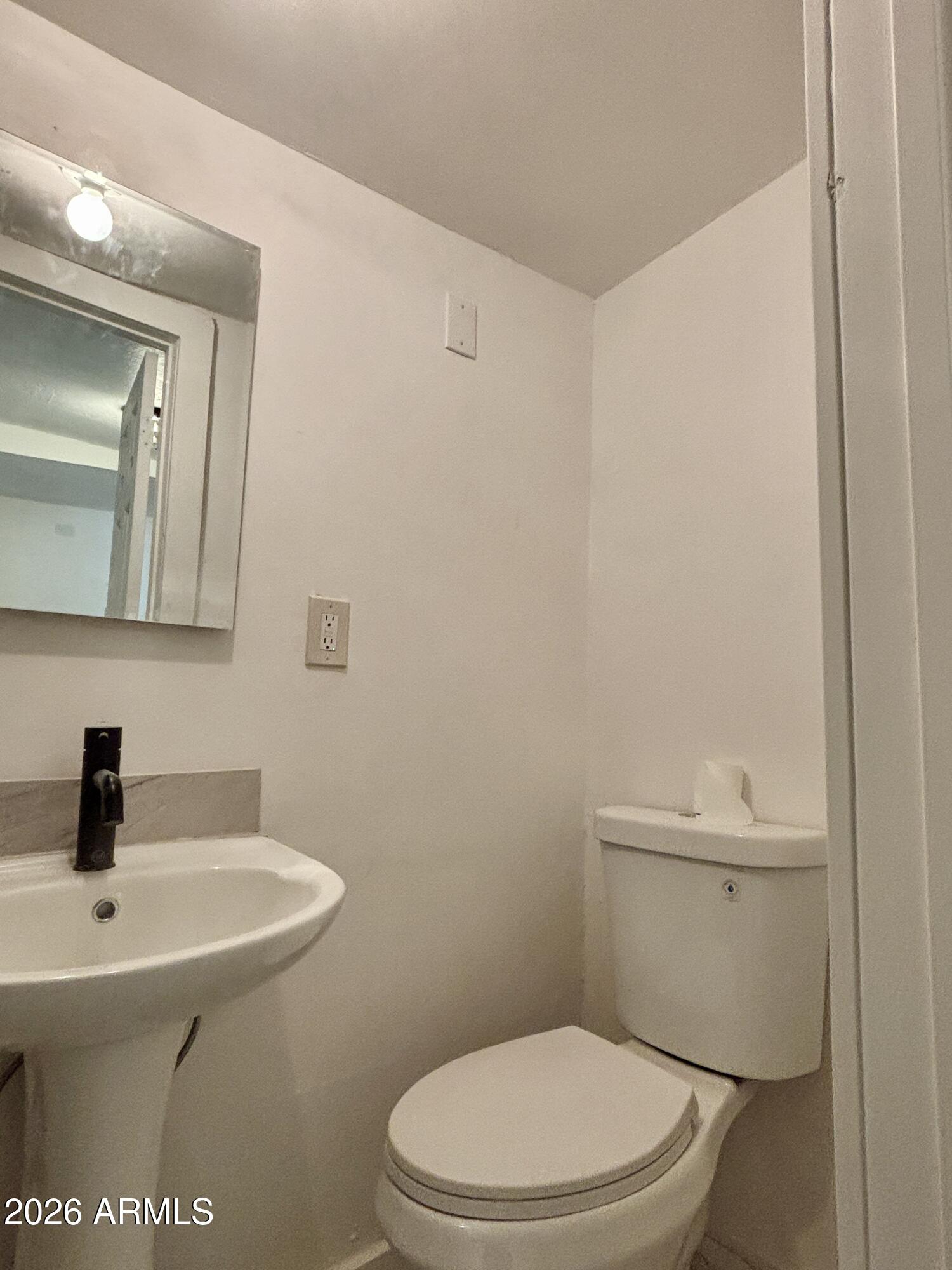 3036 West Almeria Road Phoenix, AZ 85009 - Photo 11 of 18 a bathroom with a sink a toilet and mirror
