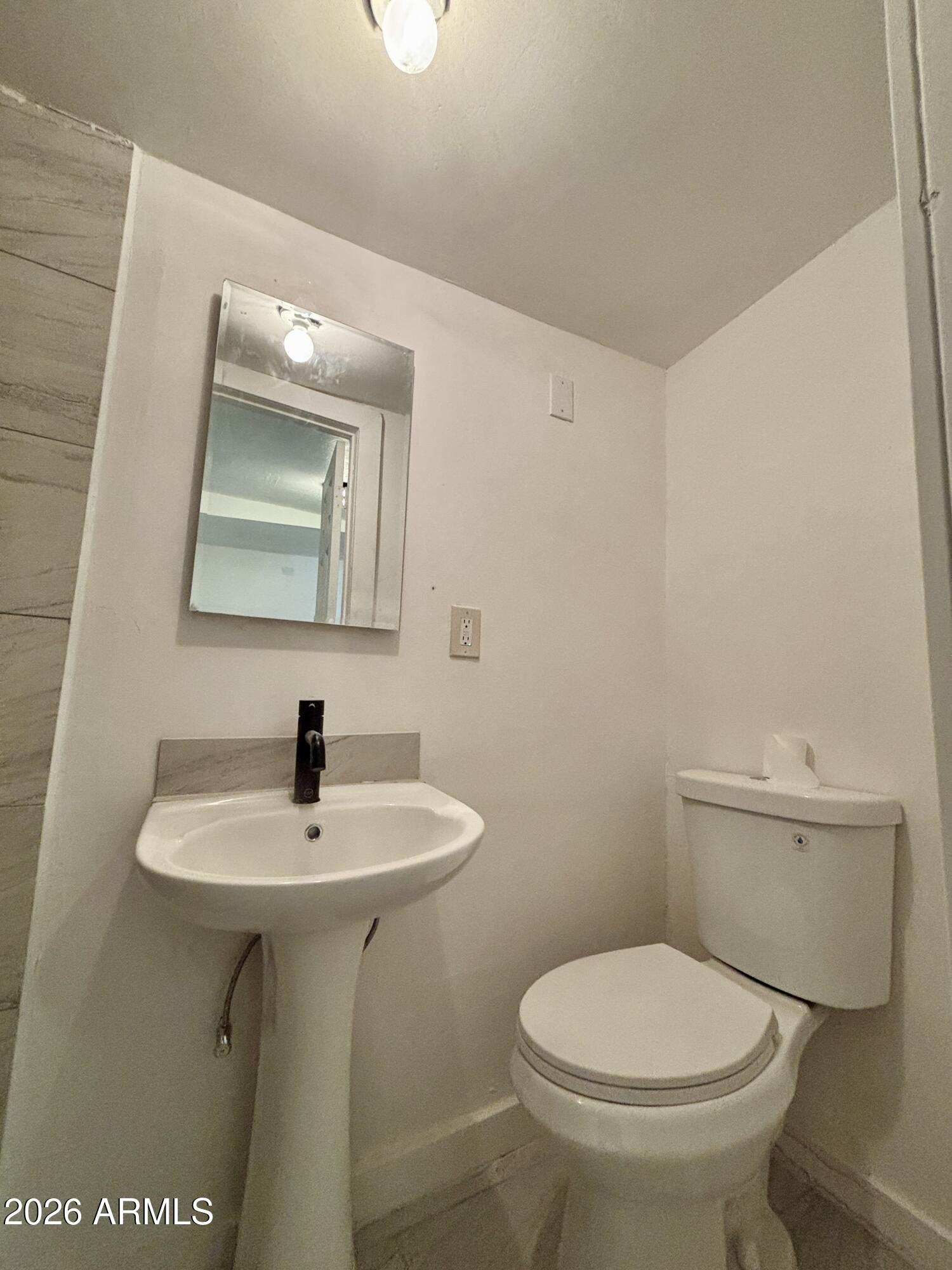 3036 West Almeria Road Phoenix, AZ 85009 - Photo 12 of 18 a bathroom with a toilet sink and mirror