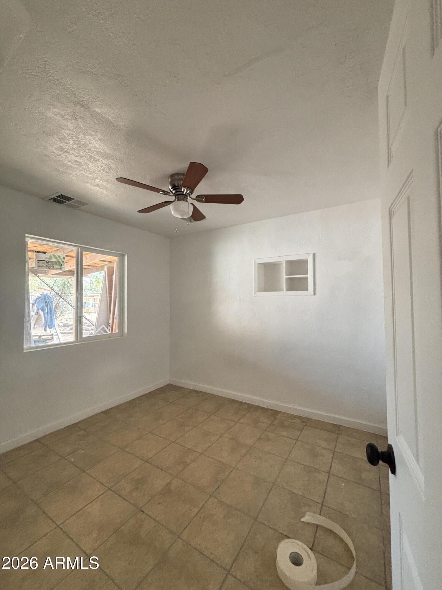 3036 West Almeria Road Phoenix, AZ 85009 - Photo 14 of 18 a view of an empty room with a window