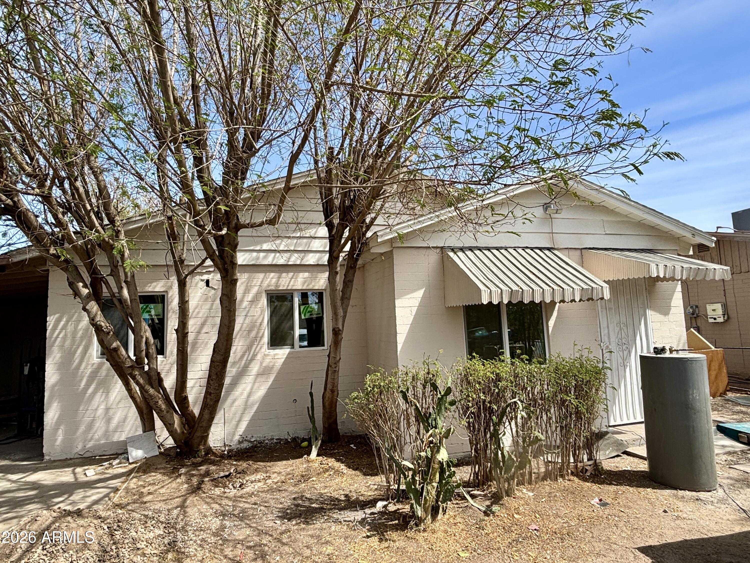 3036 West Almeria Road Phoenix, AZ 85009 - Photo 6 of 18 a front view of a house with garden
