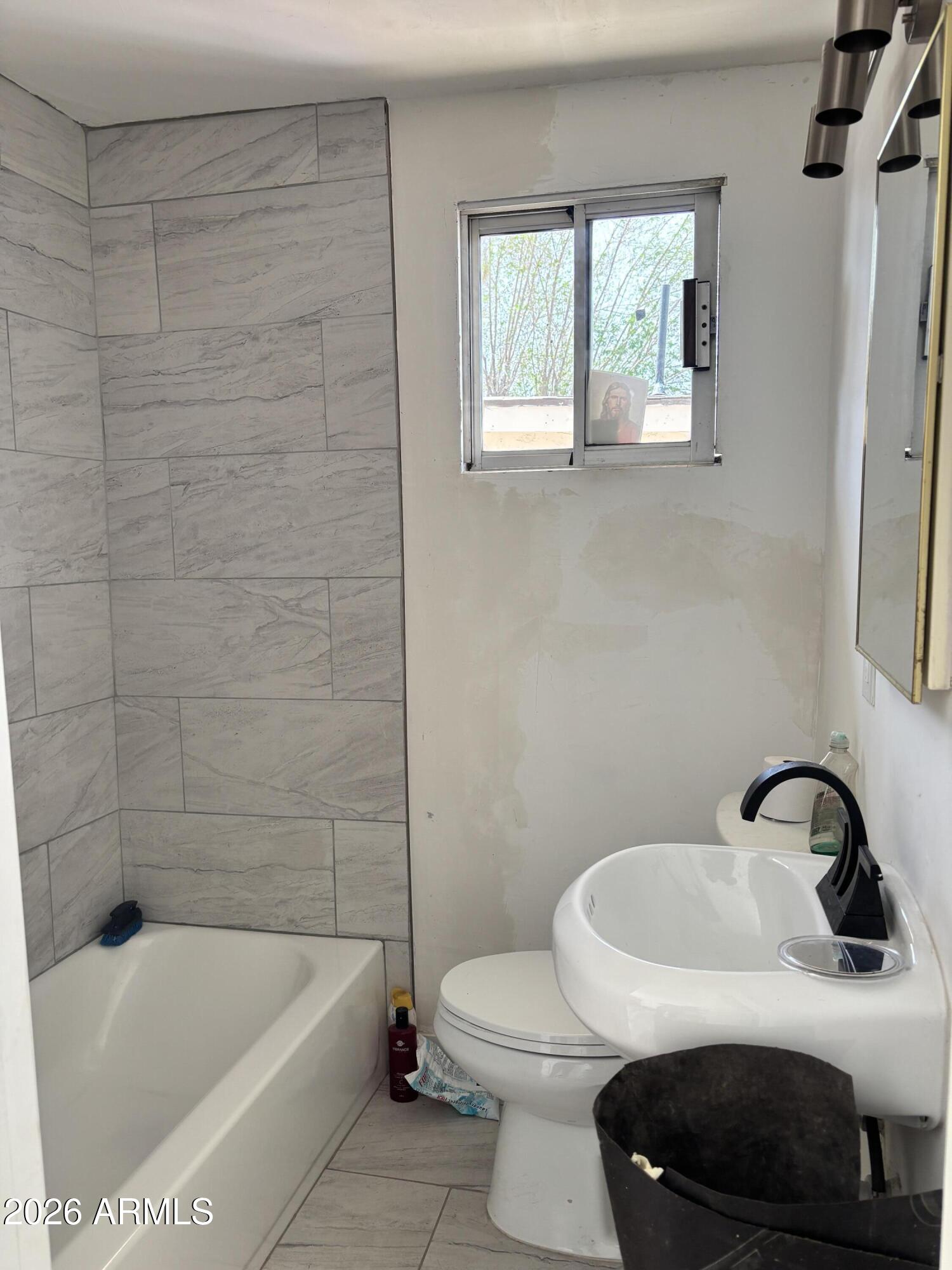 3036 West Almeria Road Phoenix, AZ 85009 - Photo 8 of 18 a bathroom with a sink a toilet and bathtub