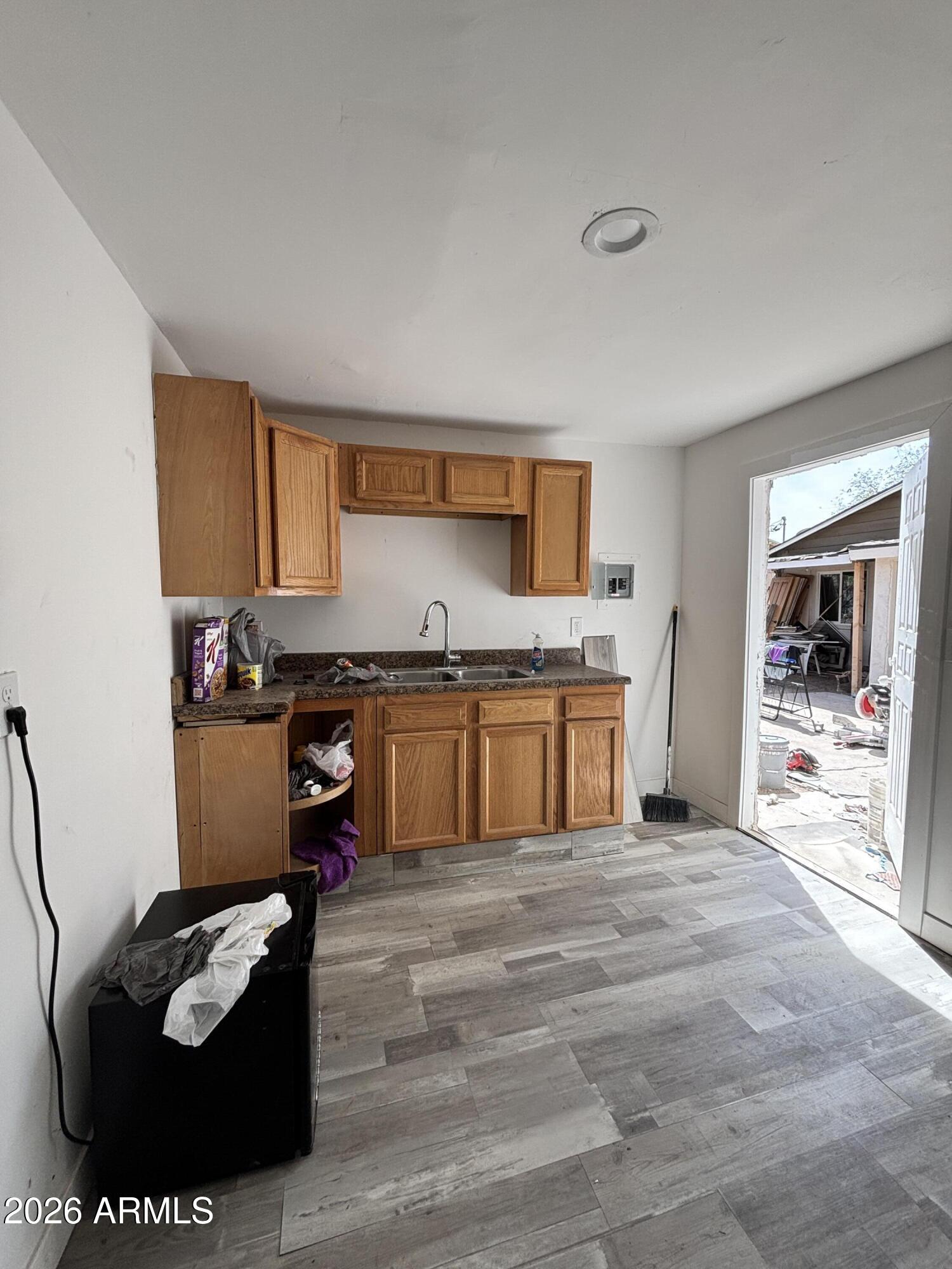 3036 West Almeria Road Phoenix, AZ 85009 - Photo 9 of 18 a kitchen with a stove a sink and a refrigerator