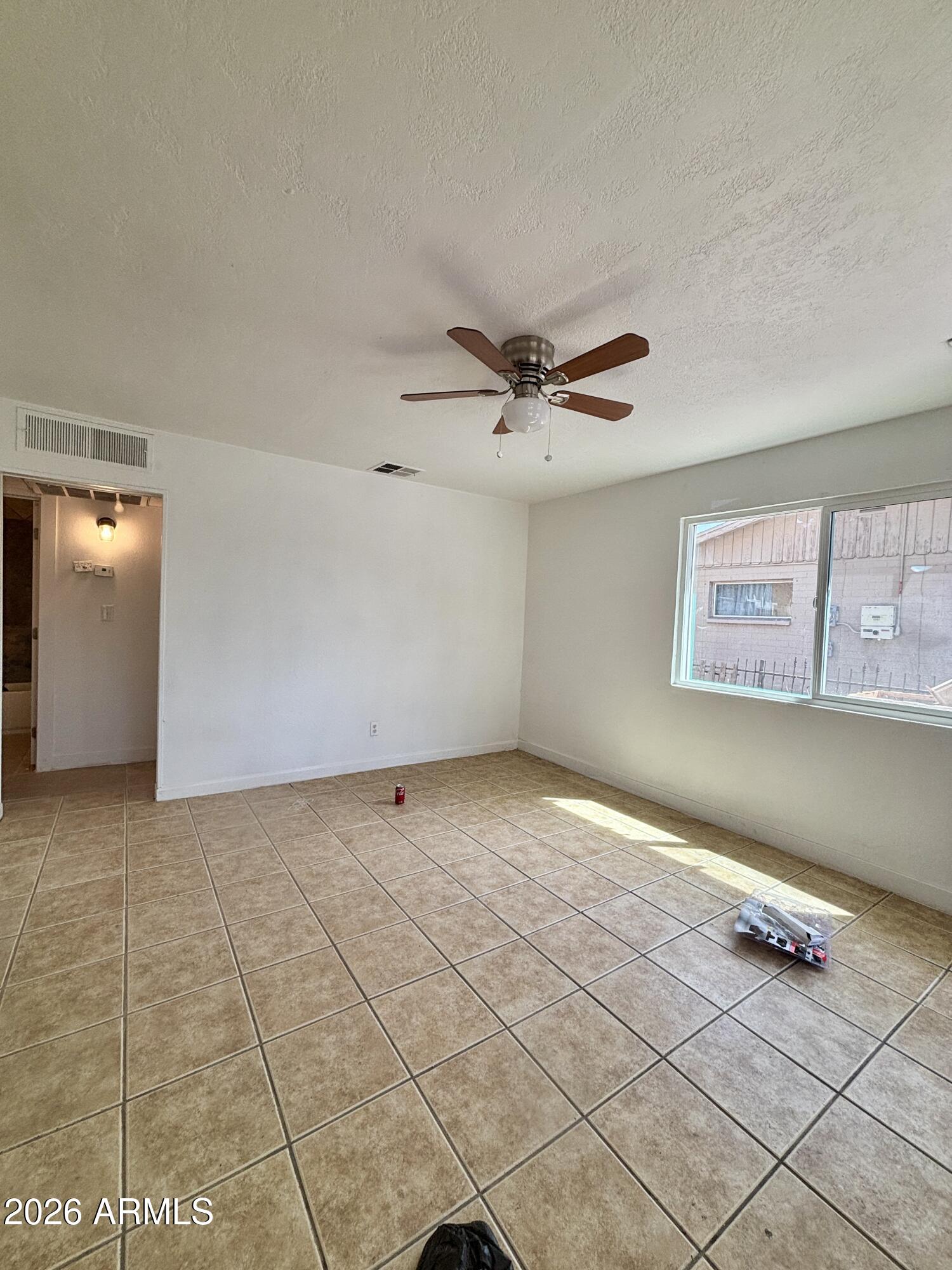 3036 West Almeria Road Phoenix, AZ 85009 - Photo 10 of 18 a view of a livingroom with a ceiling fan and window