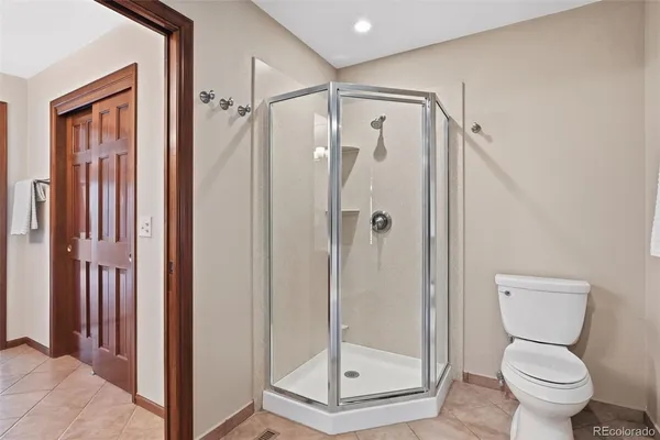 a bathroom that has a toilet and a shower