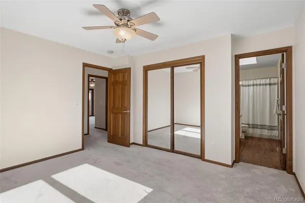 a view of empty room with ceiling fan