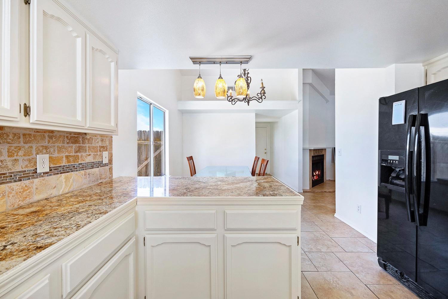 21596 Road 30 Madera, CA 93638 - Photo 29 of 57 a view of a kitchen with a sink chandelier and refrigerator