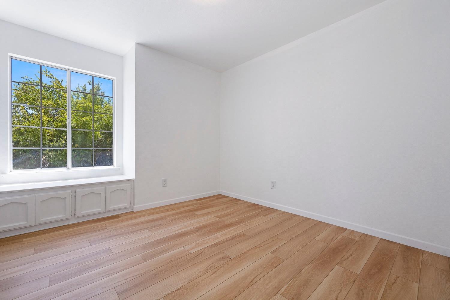 21596 Road 30 Madera, CA 93638 - Photo 36 of 57 an empty room with wooden floor and windows