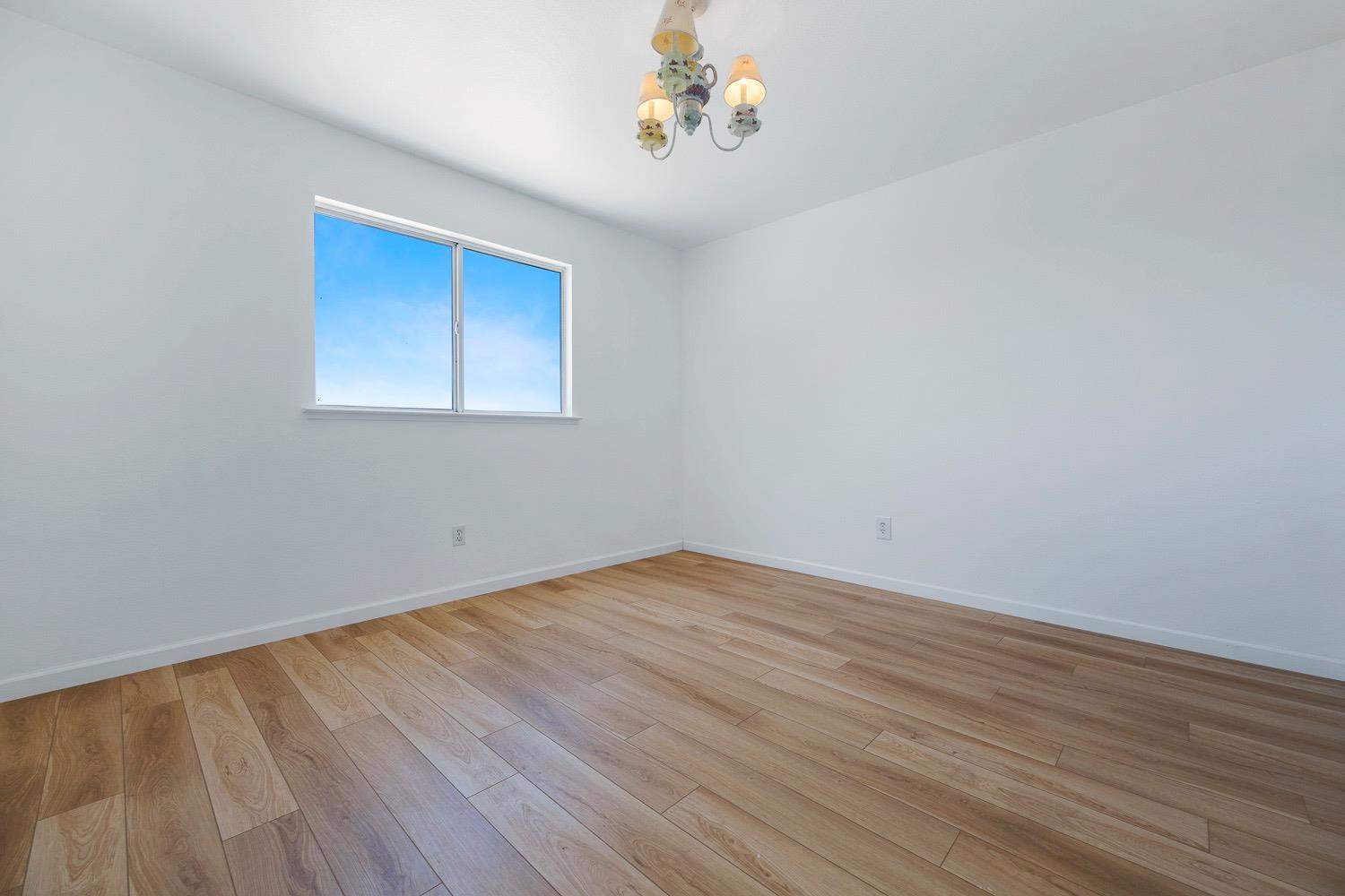 21596 Road 30 Madera, CA 93638 - Photo 41 of 57 a view of an empty room with wooden floor and a window