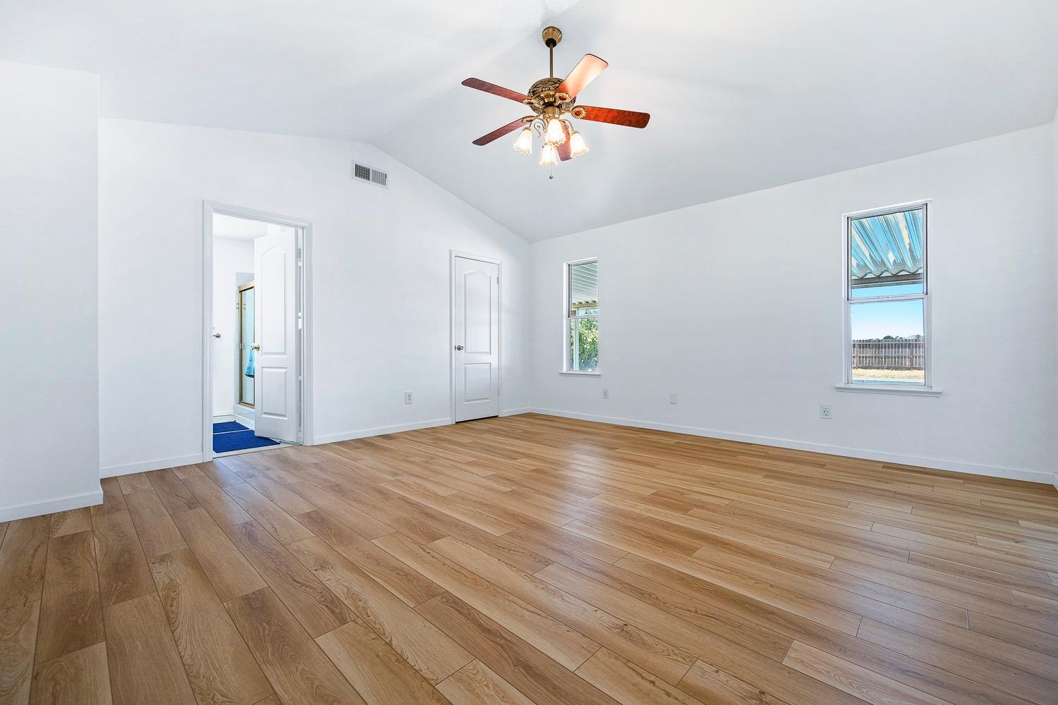 21596 Road 30 Madera, CA 93638 - Photo 43 of 57 a view of a room with wooden floor and a ceiling fan