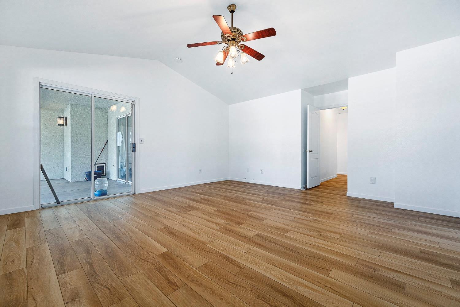21596 Road 30 Madera, CA 93638 - Photo 45 of 57 a view of a big room with wooden floor and a chandelier fan