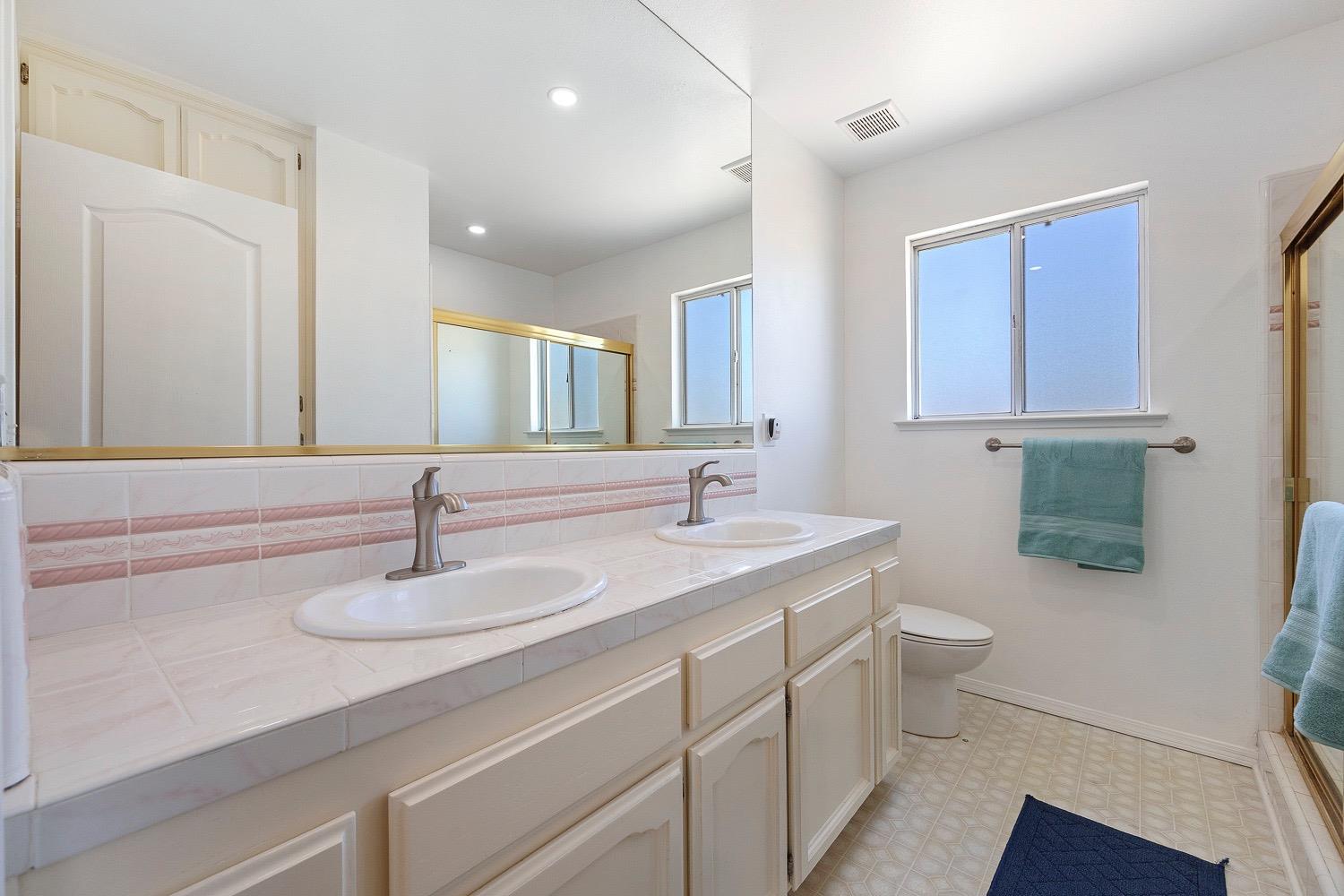 21596 Road 30 Madera, CA 93638 - Photo 46 of 57 a bathroom with a sink a toilet and mirror