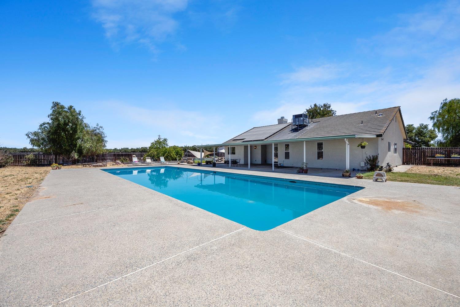 21596 Road 30 Madera, CA 93638 - Photo 51 of 57 a view of house with outdoor space and swimming pool